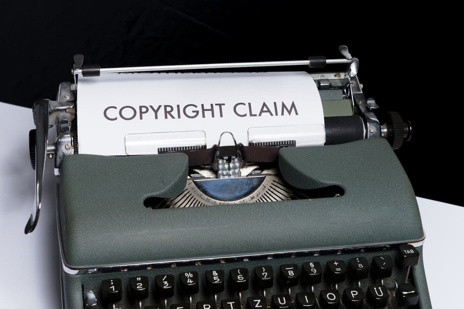 A typewriter with a sheet of paper reading Copyright Claim