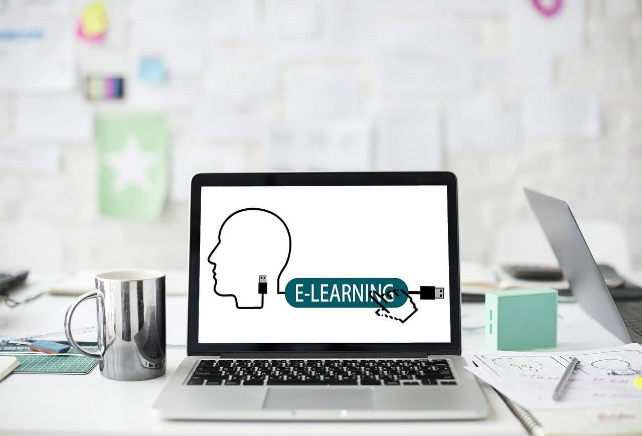 A laptop on a desk displaying an e-learning session